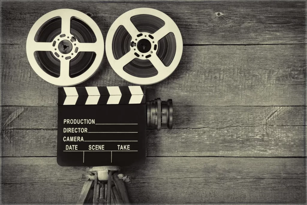 Vintage film reels and clapperboard, symbolising YouTube video content and multi-format SEO that builds stronger trust than text in 2026.