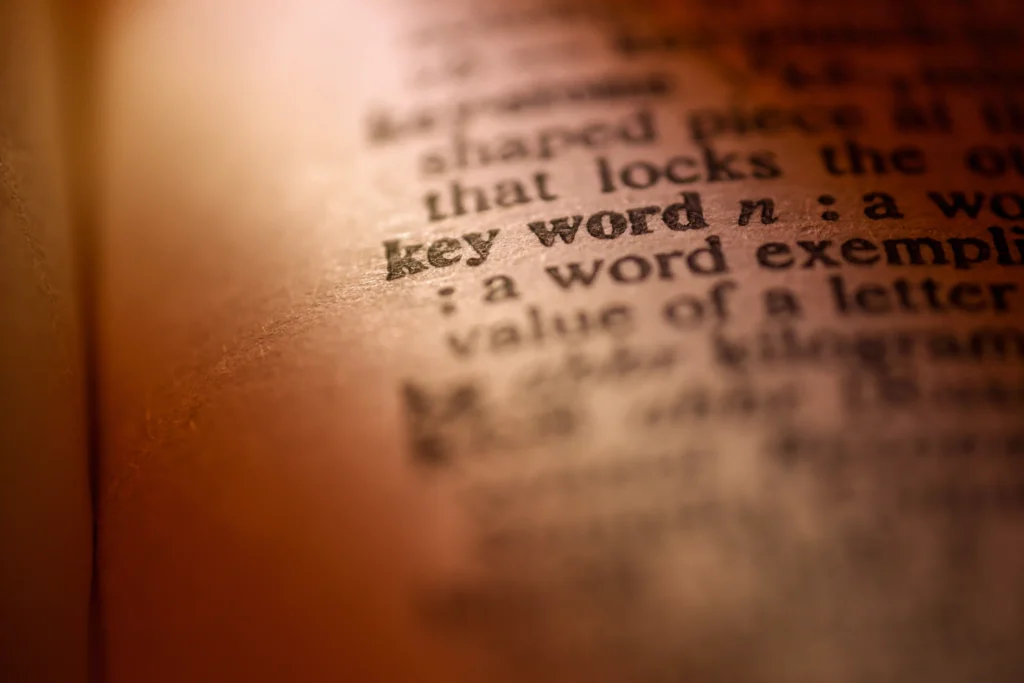 Close-up of a dictionary page highlighting the word 'keyword,' symbolizing keyword meaning, SEO relevance, and search optimization.