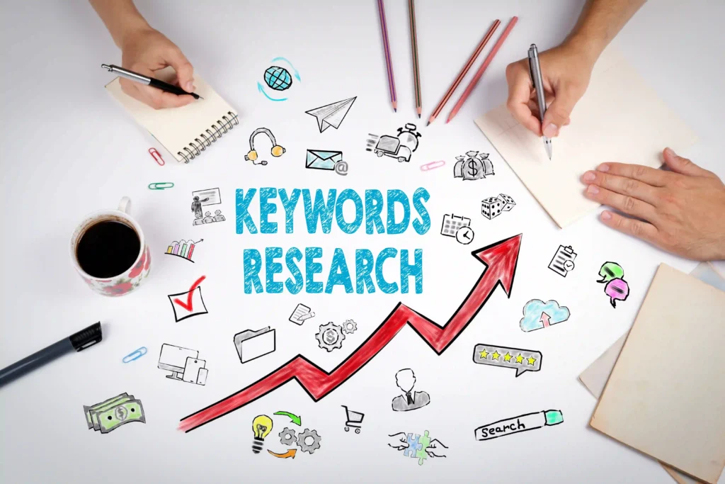 Hands writing notes around the words 'Keywords Research' with icons and a red upward arrow, symbolizing SEO growth through keyword strategy.