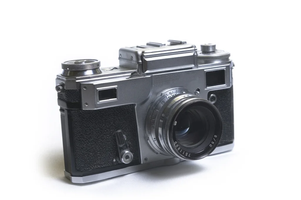 A vintage-style camera displayed in a bright studio image, used to illustrate how descriptive alt text helps search engines and users understand visual content.