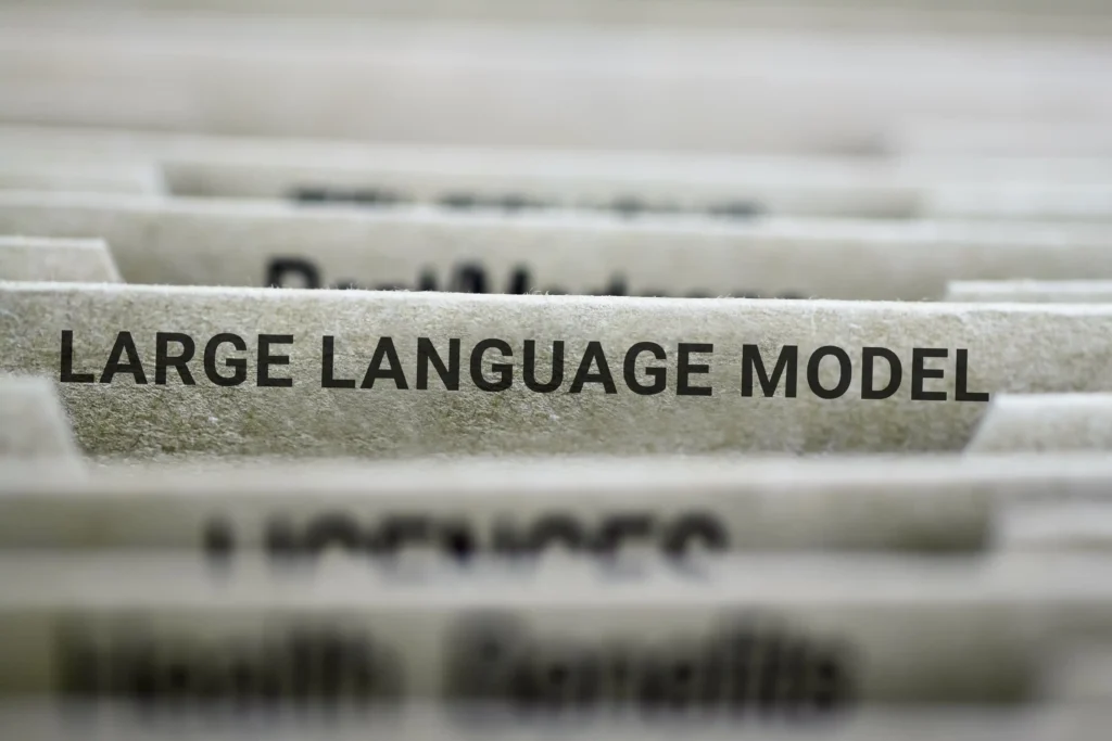 Close-up of file folders labelled “Large Language Model,” representing how AI systems organise information and influence modern search.