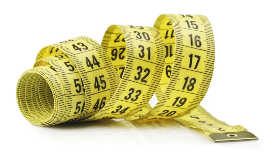 Yellow measuring tape coiled and extended, representing measurement and length in the context of domain name length.